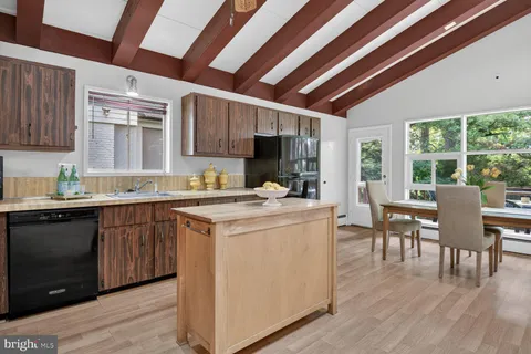 a kitchen with a table chairs stove and cabinets