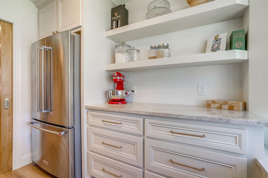 4521 Cloudview Road Fort Worth, TX 76109 - Photo 20 of 40 a kitchen with refrigerator and cabinets