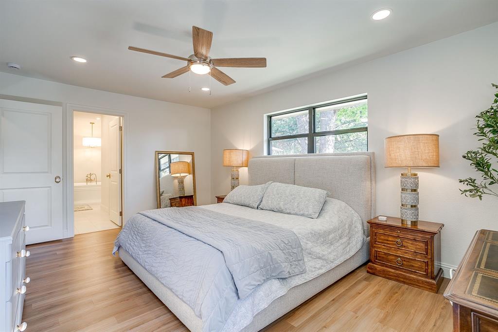 4521 Cloudview Road Fort Worth, TX 76109 - Photo 23 of 40 a bedroom with a bed and wooden floor