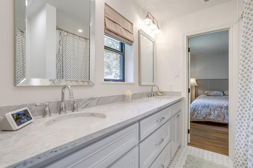 4521 Cloudview Road Fort Worth, TX 76109 - Photo 32 of 40 a en suite bathroom with double sink and a mirror