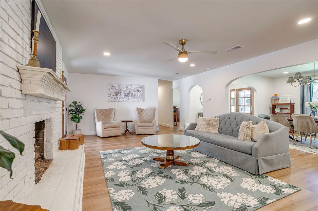 4521 Cloudview Road Fort Worth, TX 76109 - Photo 10 of 40 a living room with furniture a fireplace and a chandelier