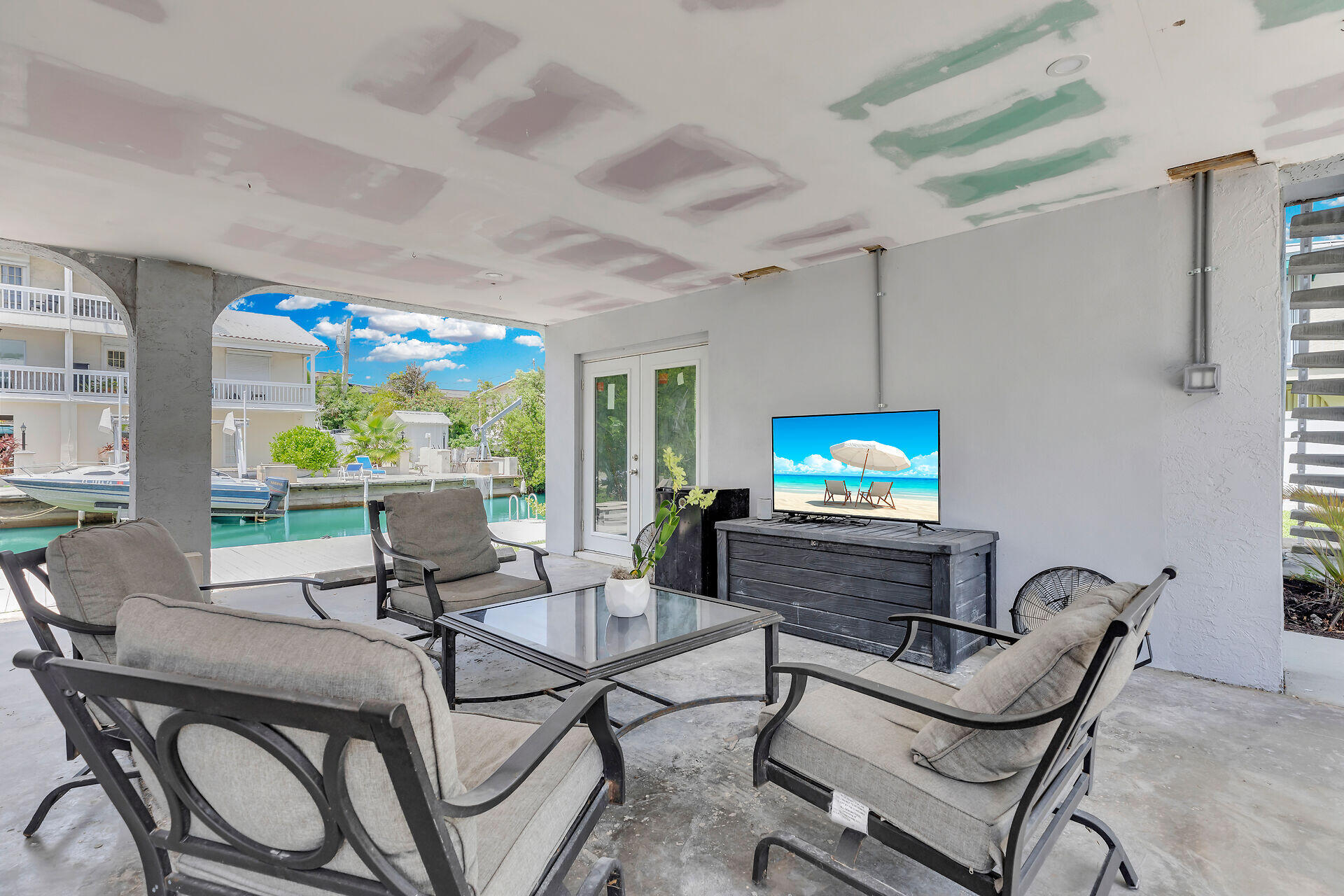 38 Calle Uno Key West, FL 33040 - Photo 3 of 13 a living room with furniture a flat screen tv and a large window