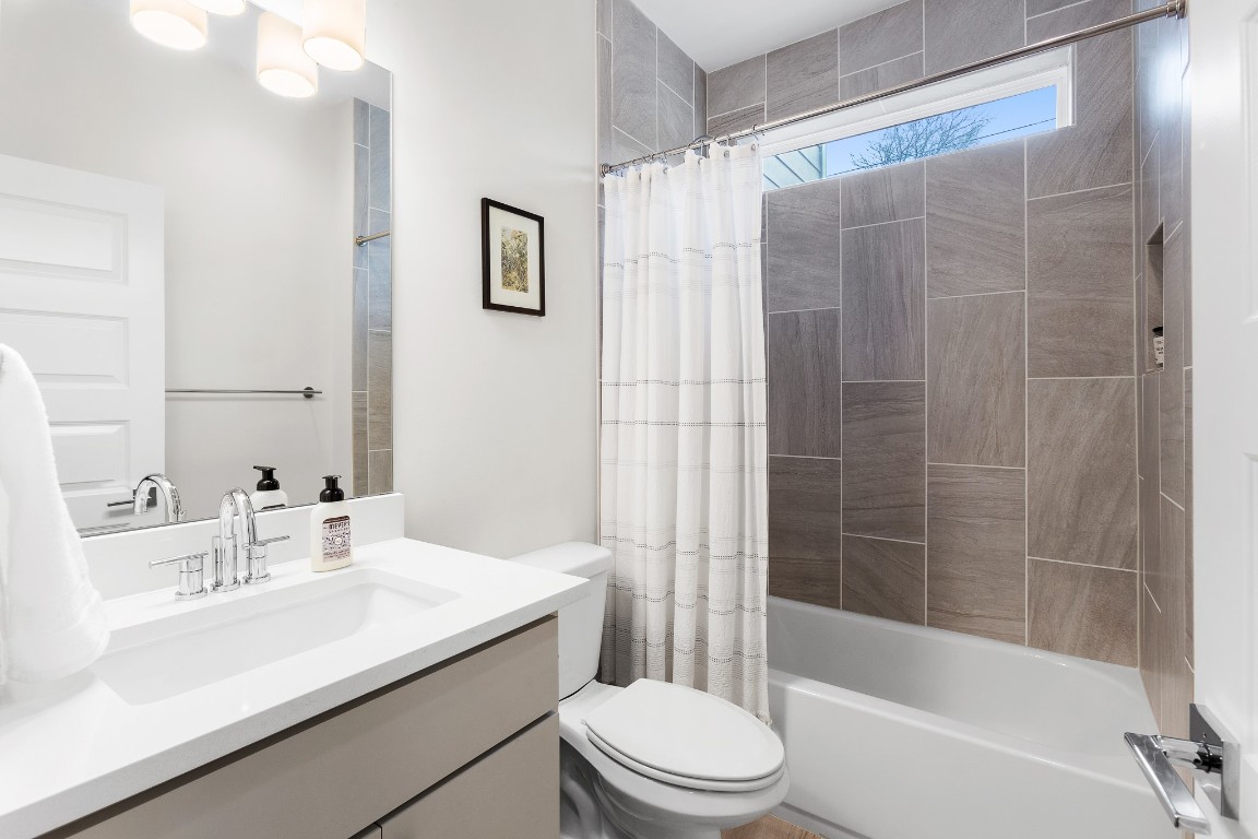 3101 Sunnylawn Circle, Unit B Austin, TX 78723 - Photo 18 of 28 Bathroom with shower / bathtub combination with curtain and vanity