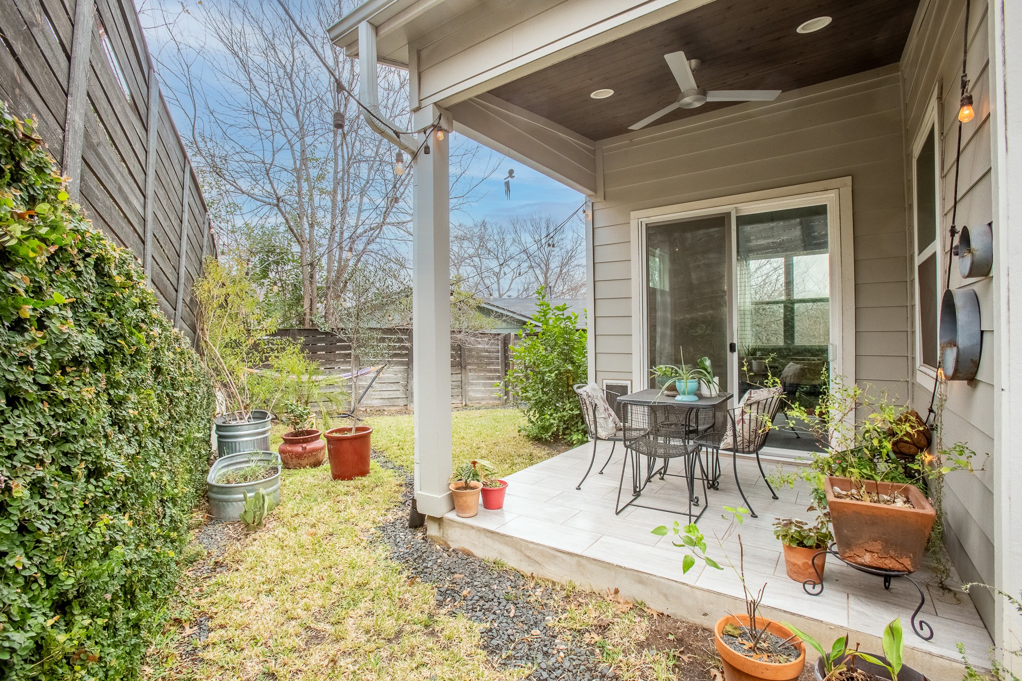 3101 Sunnylawn Circle, Unit B Austin, TX 78723 - Photo 24 of 32 Fenced backyard with a ceiling fan, a patio area, and outdoor dining area