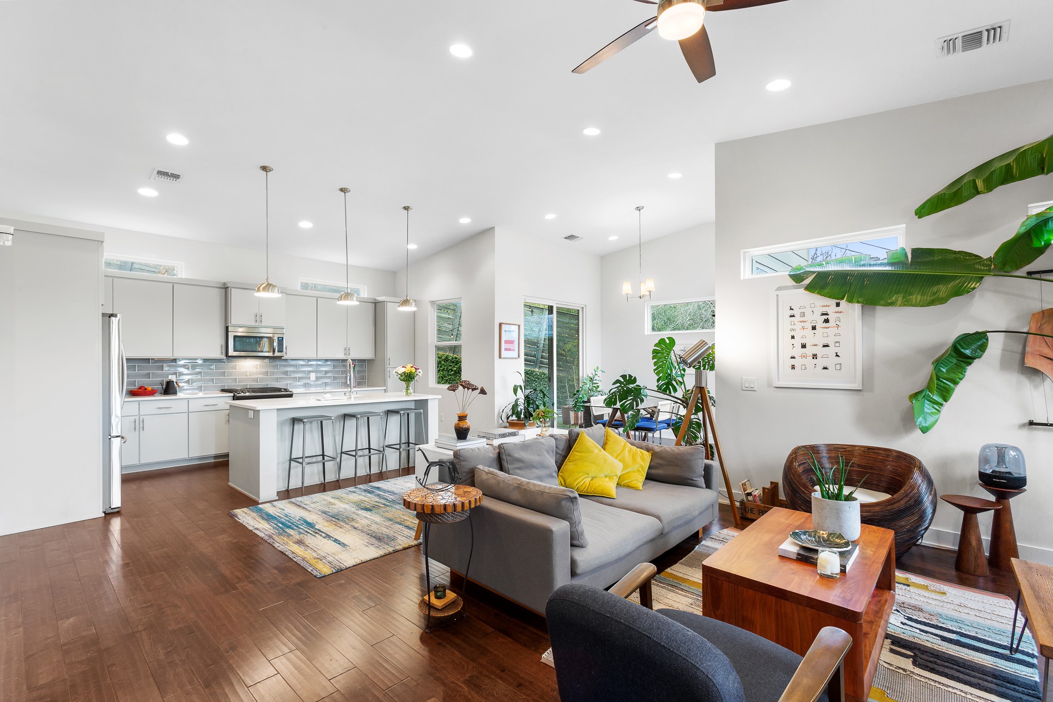 3101 Sunnylawn Circle, Unit B Austin, TX 78723 - Photo 30 of 32 Living area featuring dark wood-type flooring, a ceiling fan, recessed lighting, a chandelier, and a towering ceiling