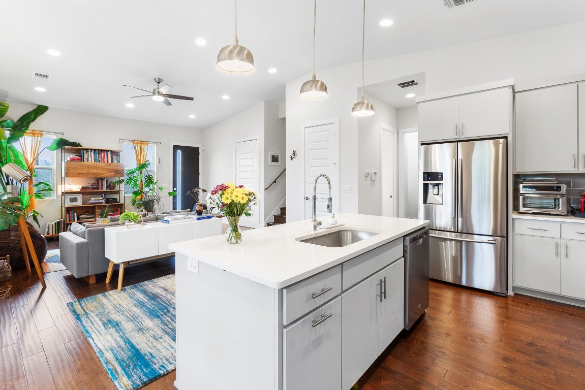 3101 Sunnylawn Circle, Unit B Austin, TX 78723 - Photo 28 of 28 Kitchen with open floor plan, stainless steel appliances, hanging light fixtures, ceiling fan, and dark wood finished floors