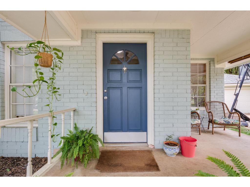 The brick façade and adorable front porch offer a warm welcome.