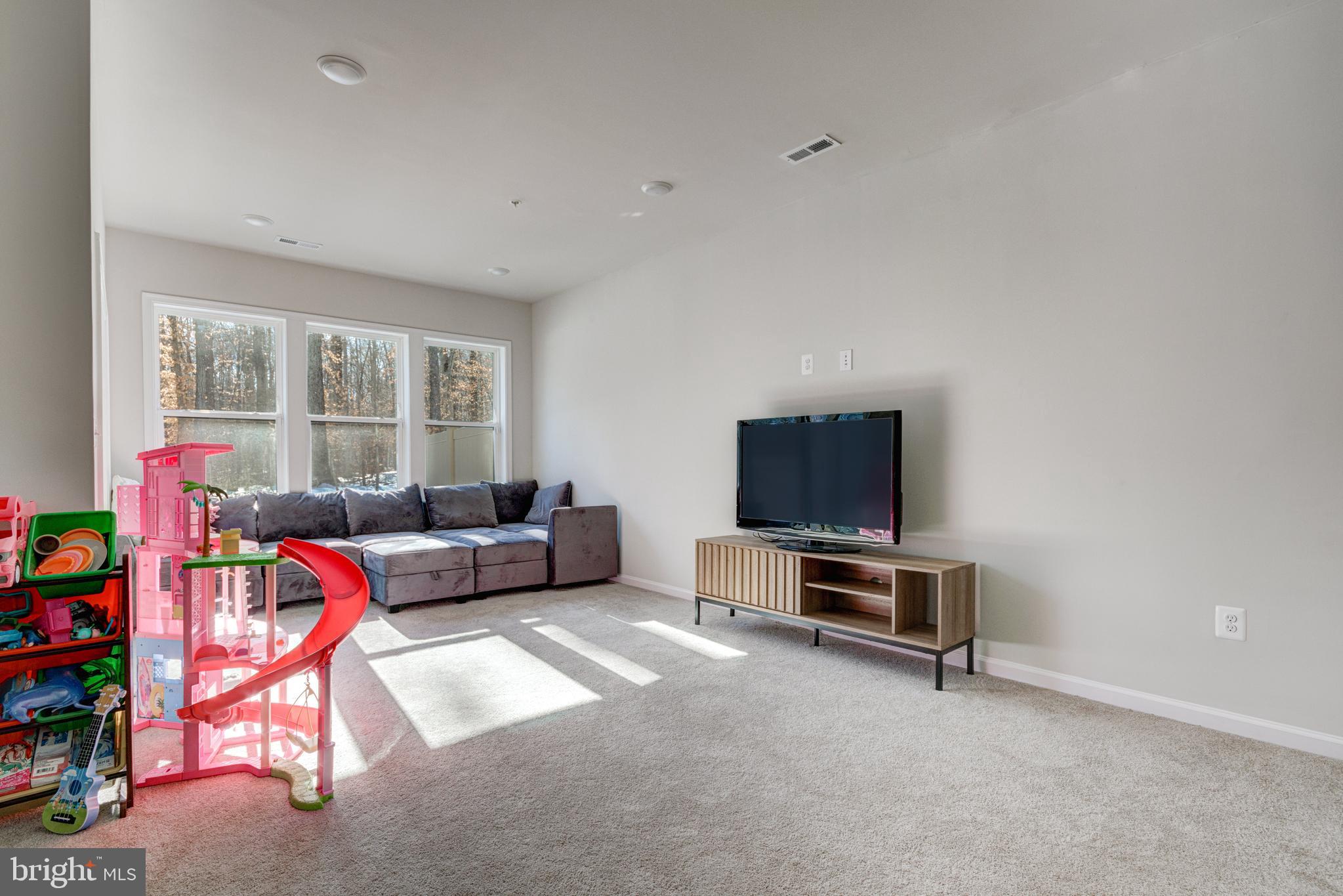 3344 Watershed Boulevard Laurel, MD 20724 - Photo 29 of 39 a living room with furniture a flat screen tv and a window