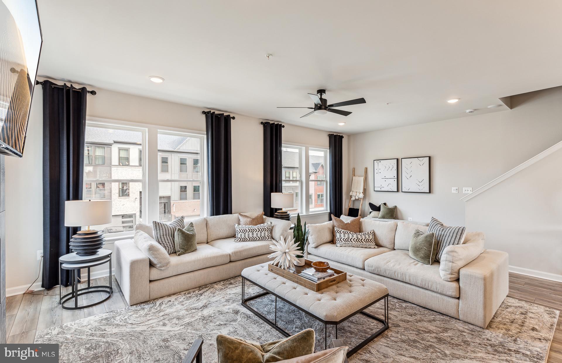 18315 Fox Xing Terrace Leesburg, VA 20176 - Photo 5 of 37 a living room with furniture ceiling fan and a rug