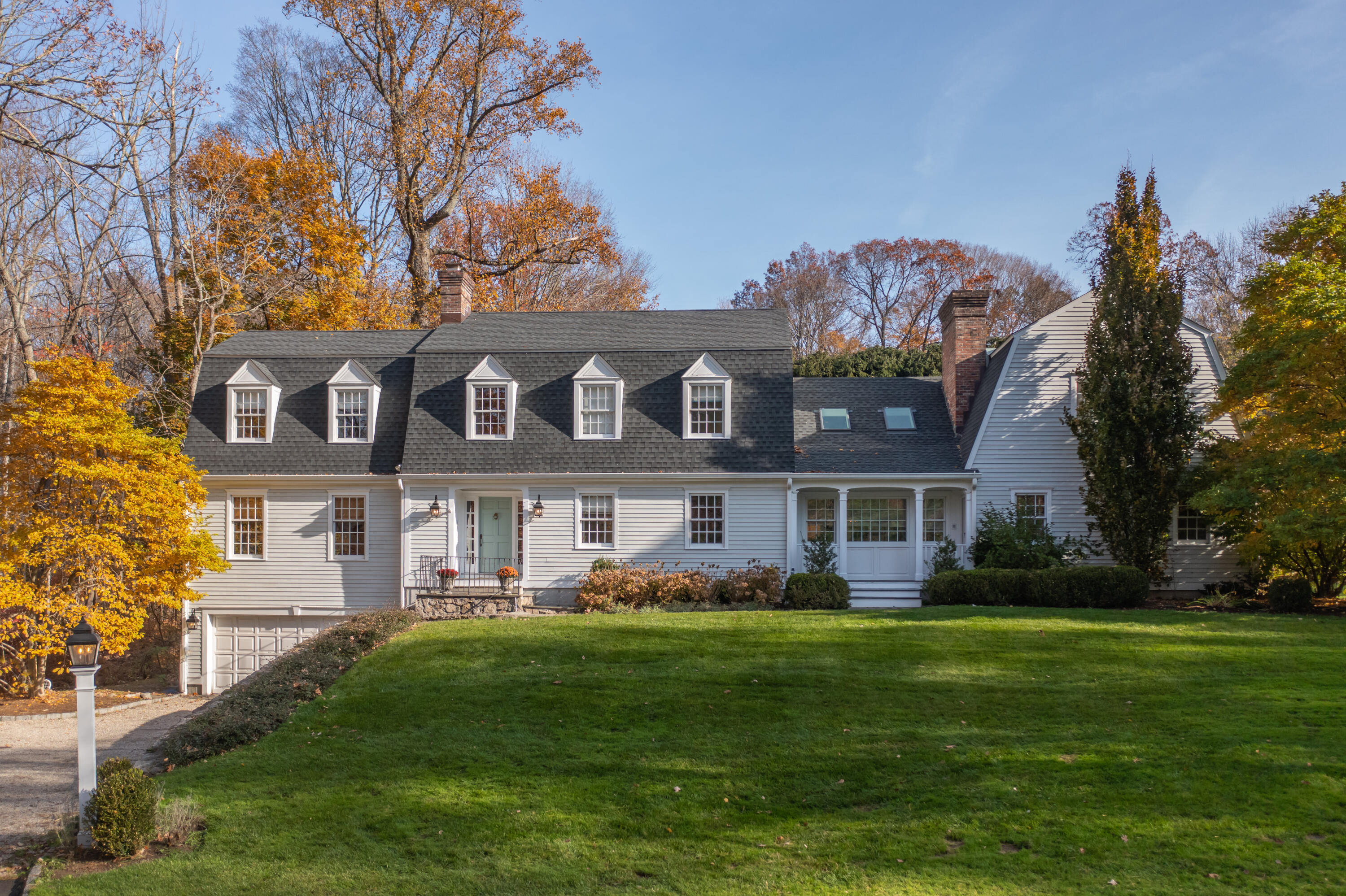 a front view of house with yard and green space