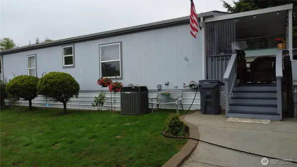 a view of a house with backyard and sitting area