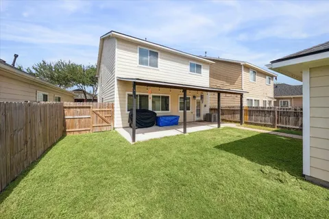 a view of a house with backyard and porch