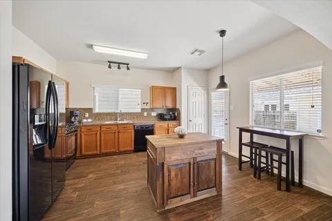 a kitchen with a sink appliances and cabinets