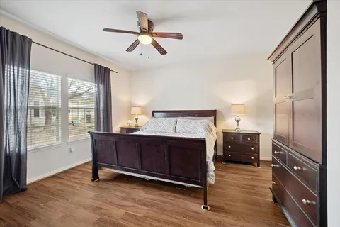 a view of bedroom with furniture window and wooden floor