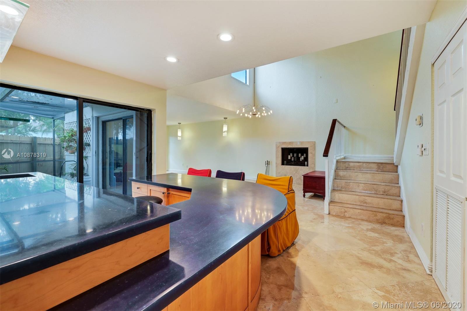 74 Ivy Road Hollywood, FL 33021 - Photo 12 of 55 a dining hall with stainless steel appliances kitchen island granite countertop wooden cabinets and couch