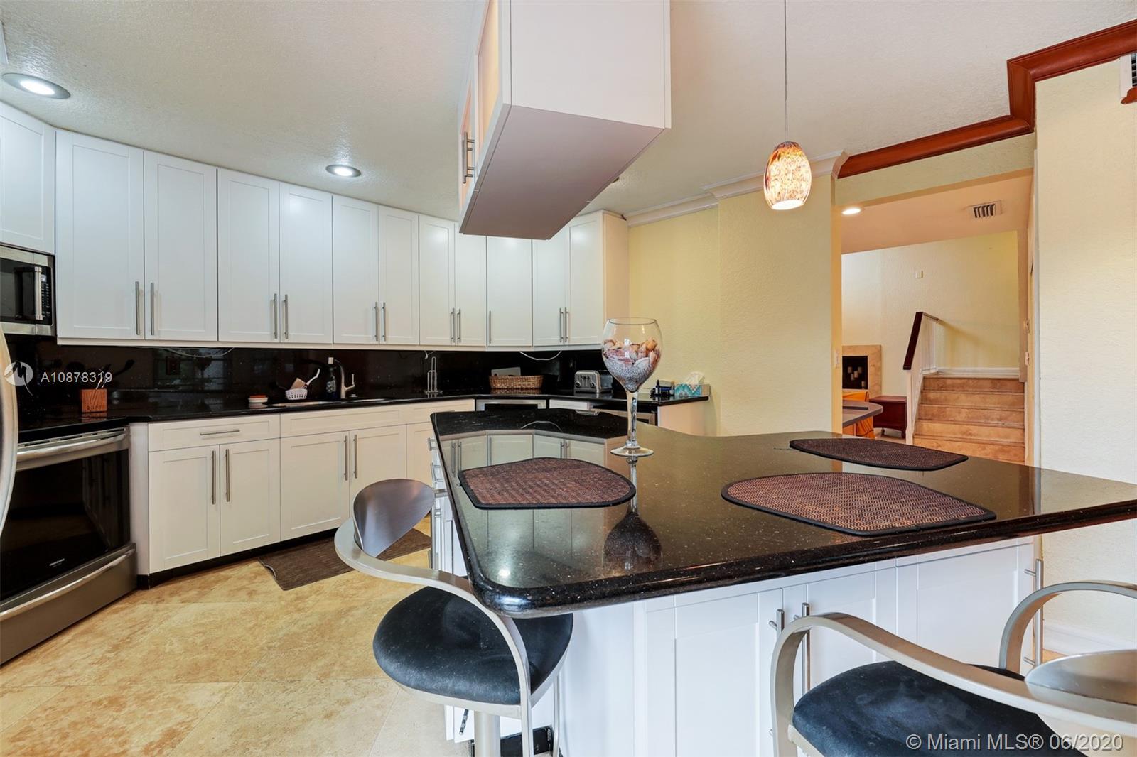 74 Ivy Road Hollywood, FL 33021 - Photo 15 of 55 a kitchen with stainless steel appliances granite countertop a sink a stove counter space and cabinets