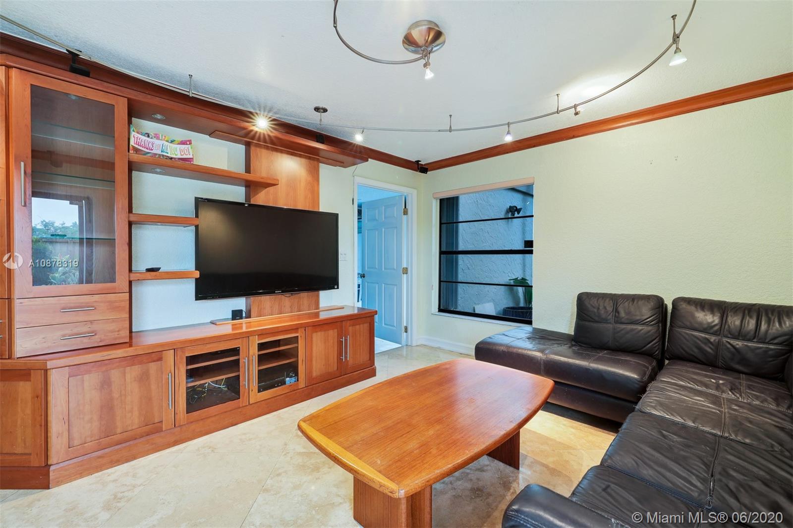 74 Ivy Road Hollywood, FL 33021 - Photo 19 of 55 a living room with furniture and a flat screen tv