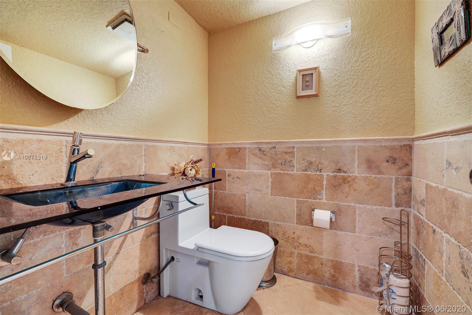 74 Ivy Road Hollywood, FL 33021 - Photo 22 of 55 a bathroom with a toilet a sink and mirror