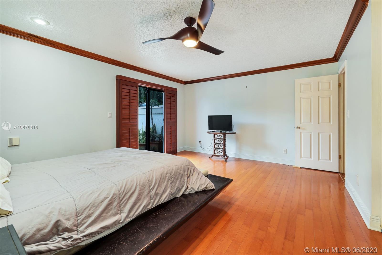 74 Ivy Road Hollywood, FL 33021 - Photo 28 of 55 a bedroom with a bed and a table