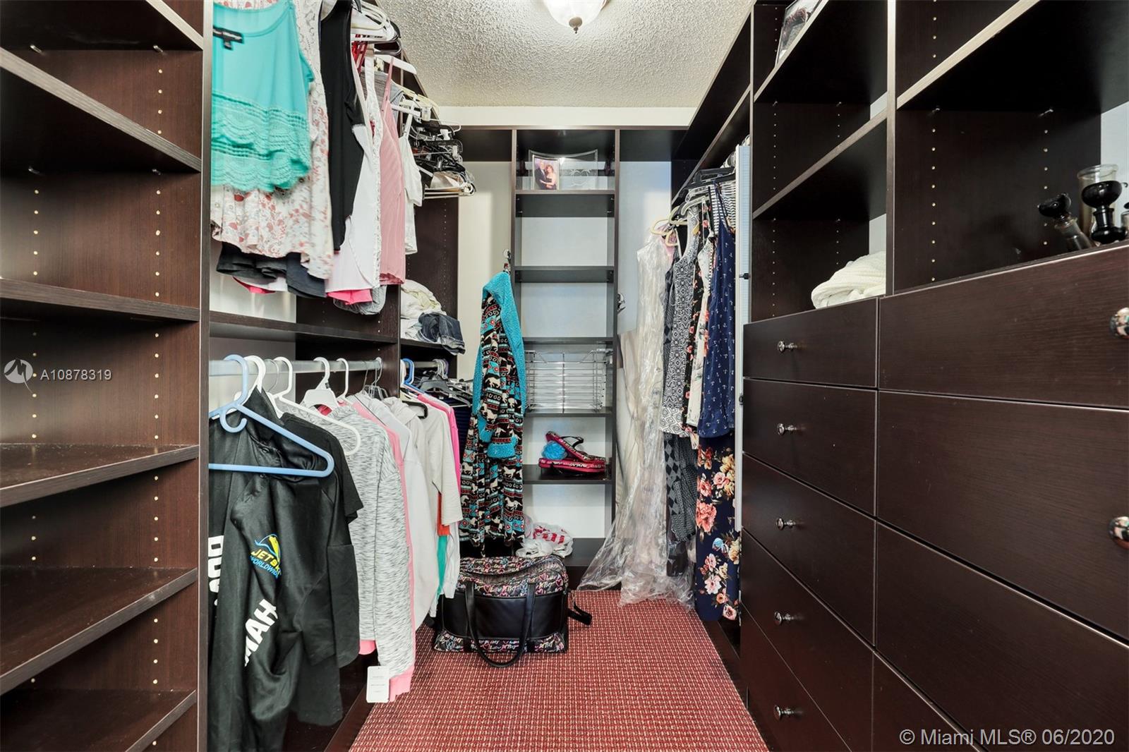74 Ivy Road Hollywood, FL 33021 - Photo 30 of 55 a view of walk in closet with clothes and shoes