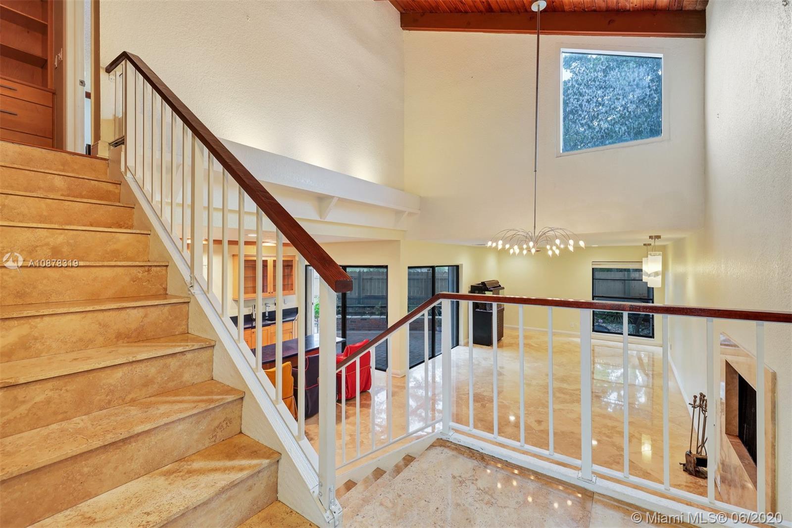 74 Ivy Road Hollywood, FL 33021 - Photo 3 of 55 a view of staircase with lots of frames on wall and a large window