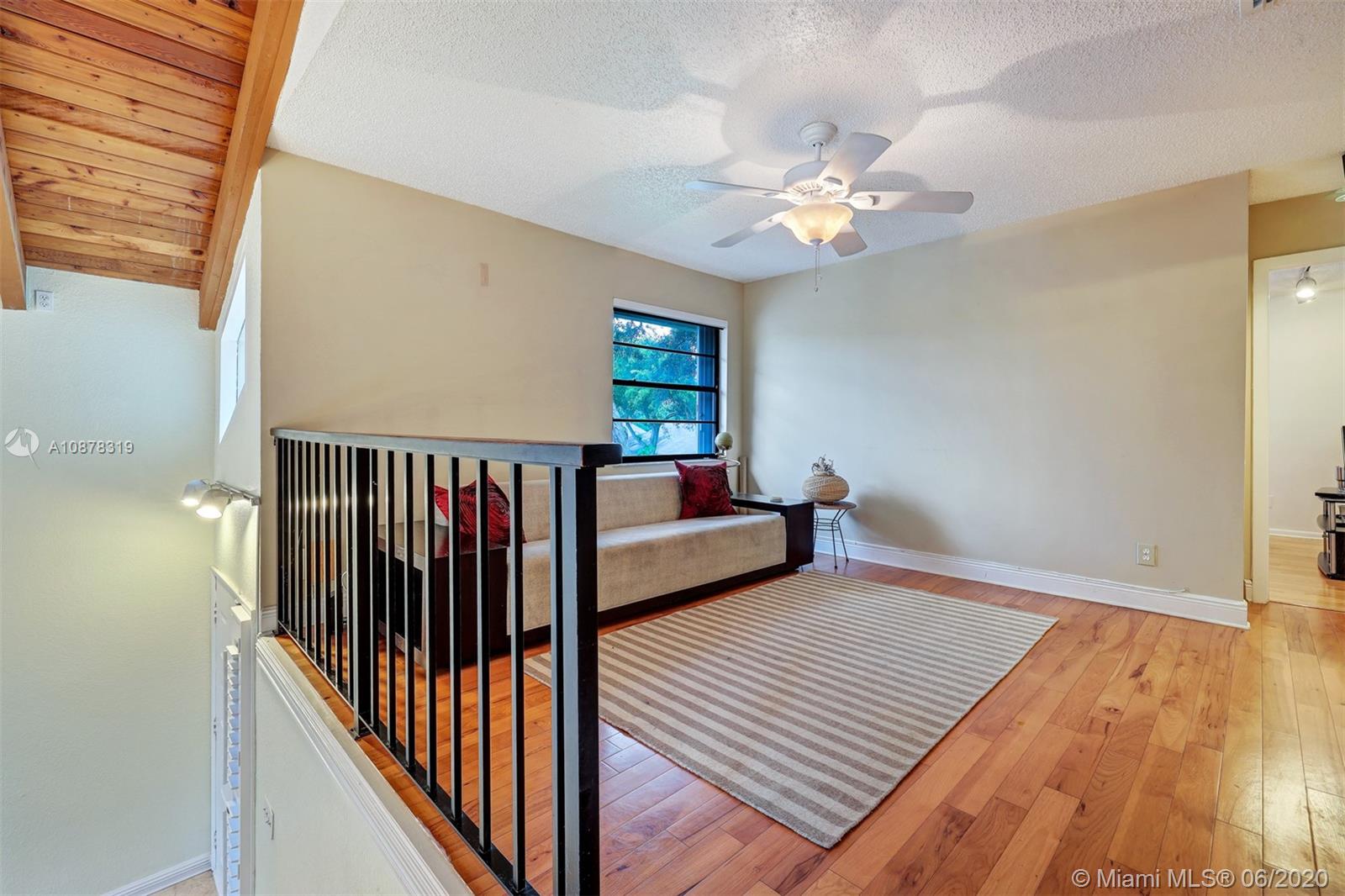 74 Ivy Road Hollywood, FL 33021 - Photo 31 of 55 a view of a hallway with wooden floor and a ceiling fan