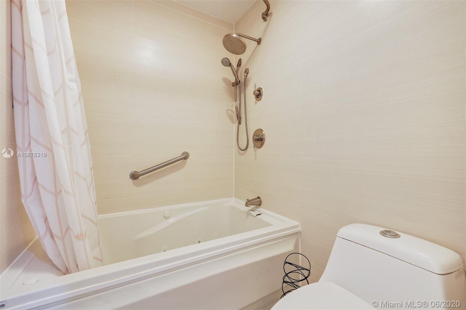 74 Ivy Road Hollywood, FL 33021 - Photo 37 of 55 a bathroom with a toilet and a bath tub