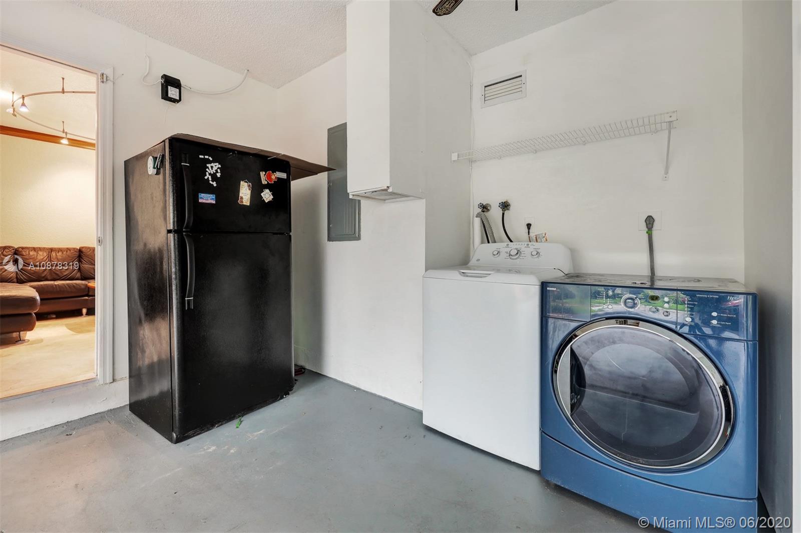 74 Ivy Road Hollywood, FL 33021 - Photo 40 of 55 a kitchen with a refrigerator and washer