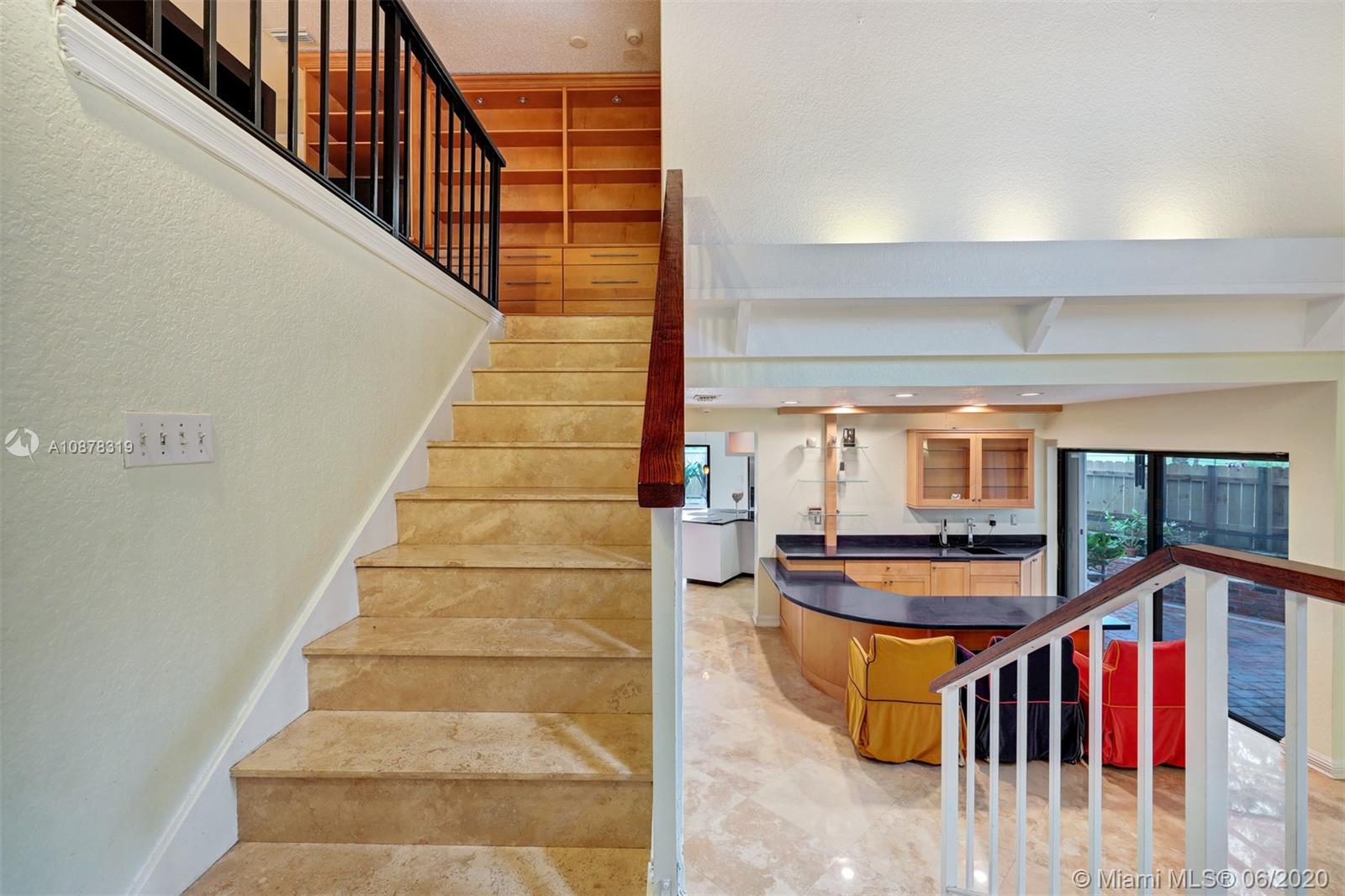 74 Ivy Road Hollywood, FL 33021 - Photo 4 of 55 a view of staircase with lots of frames on wall and windows