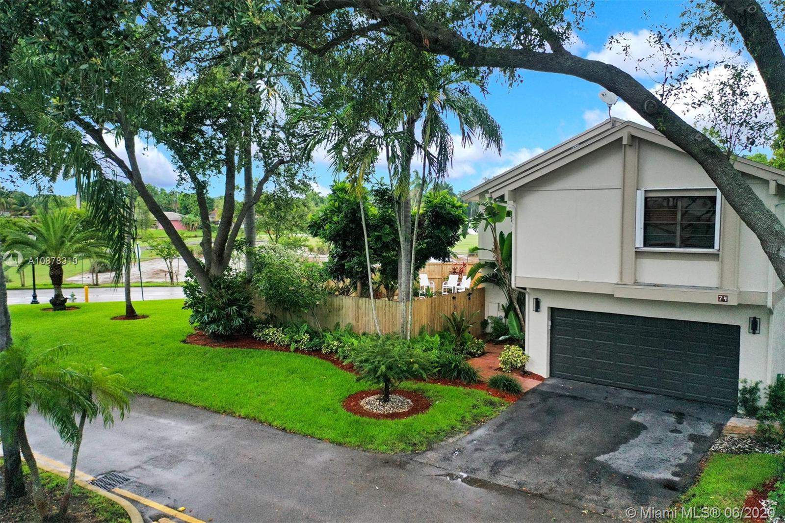 74 Ivy Road Hollywood, FL 33021 - Photo 46 of 55 a front view of a house with a garden and plants