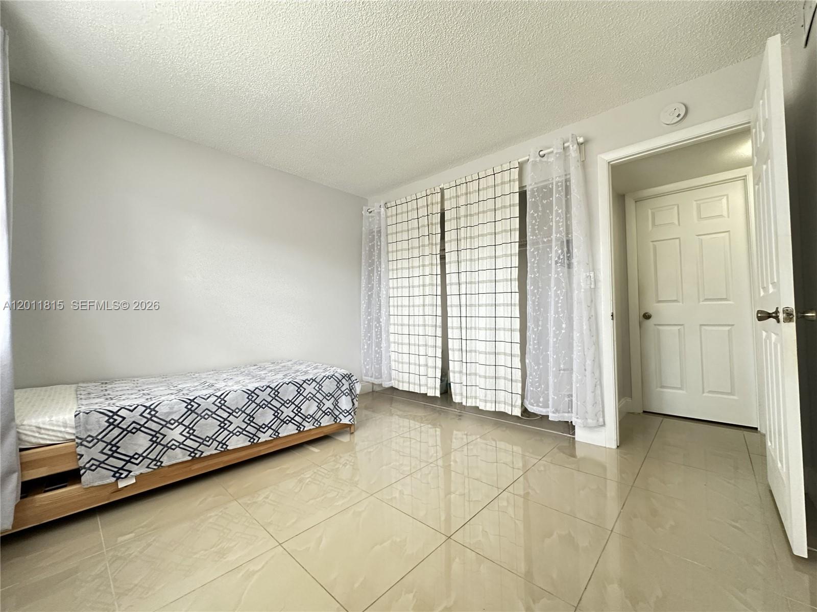 9370 Southwest 8th Street, Unit 107 Boca Raton, FL 33428 - Photo 8 of 17 a view of livingroom with hardwood floor and closet