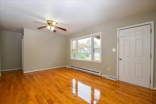 wooden floor in an empty room with a window