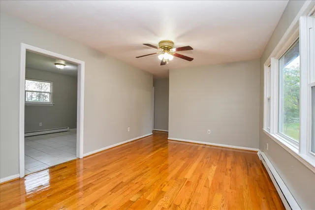 wooden floor in an empty room with a window