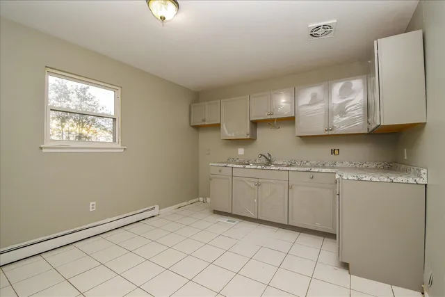 a kitchen with sink cabinets and window