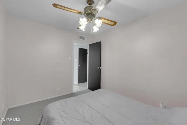 a view of a livingroom with a chandelier fan