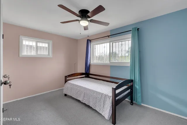 a bedroom with a bed and window