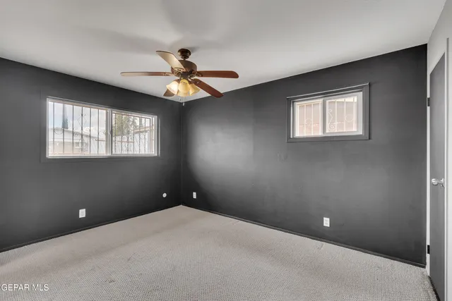 a view of a livingroom with a ceiling fan and window