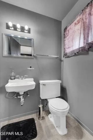a bathroom with a sink a toilet and mirror