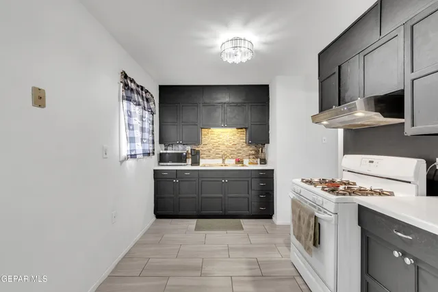 a kitchen with stainless steel appliances a stove and a refrigerator