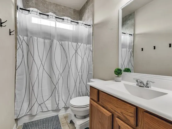 a spacious bedroom with a bed and a ceiling fan