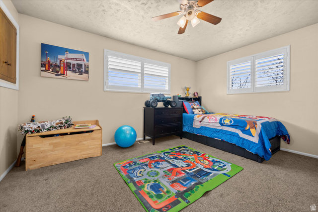 2298 West 800 North Clinton, UT 84015 - Photo 13 of 53 Carpeted bedroom featuring ceiling fan and a textured ceiling