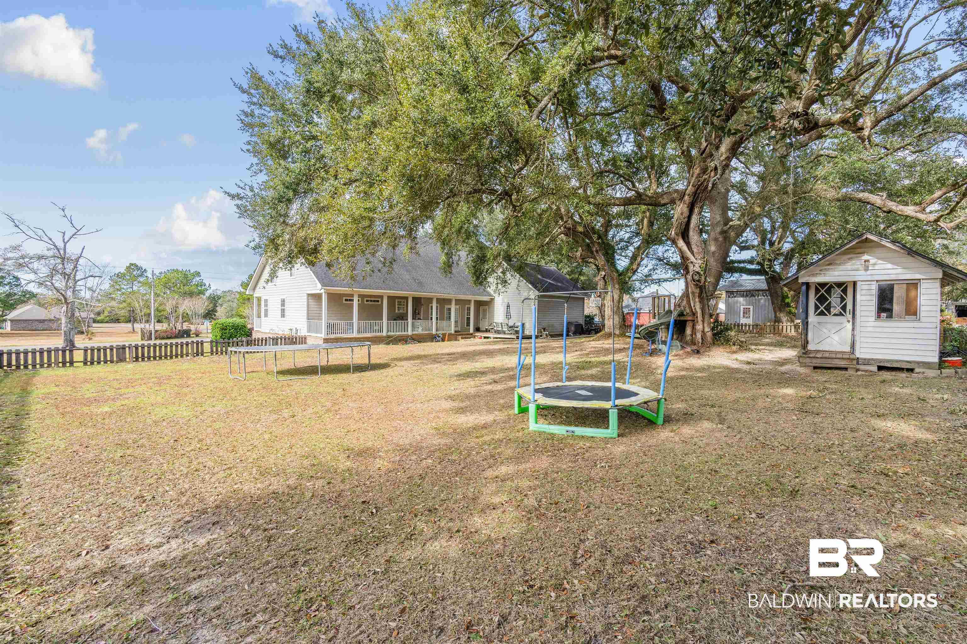 10197 Bellingrath Road Theodore, AL 36582 - Photo 35 of 37 View of yard featuring a trampoline and a storage shed