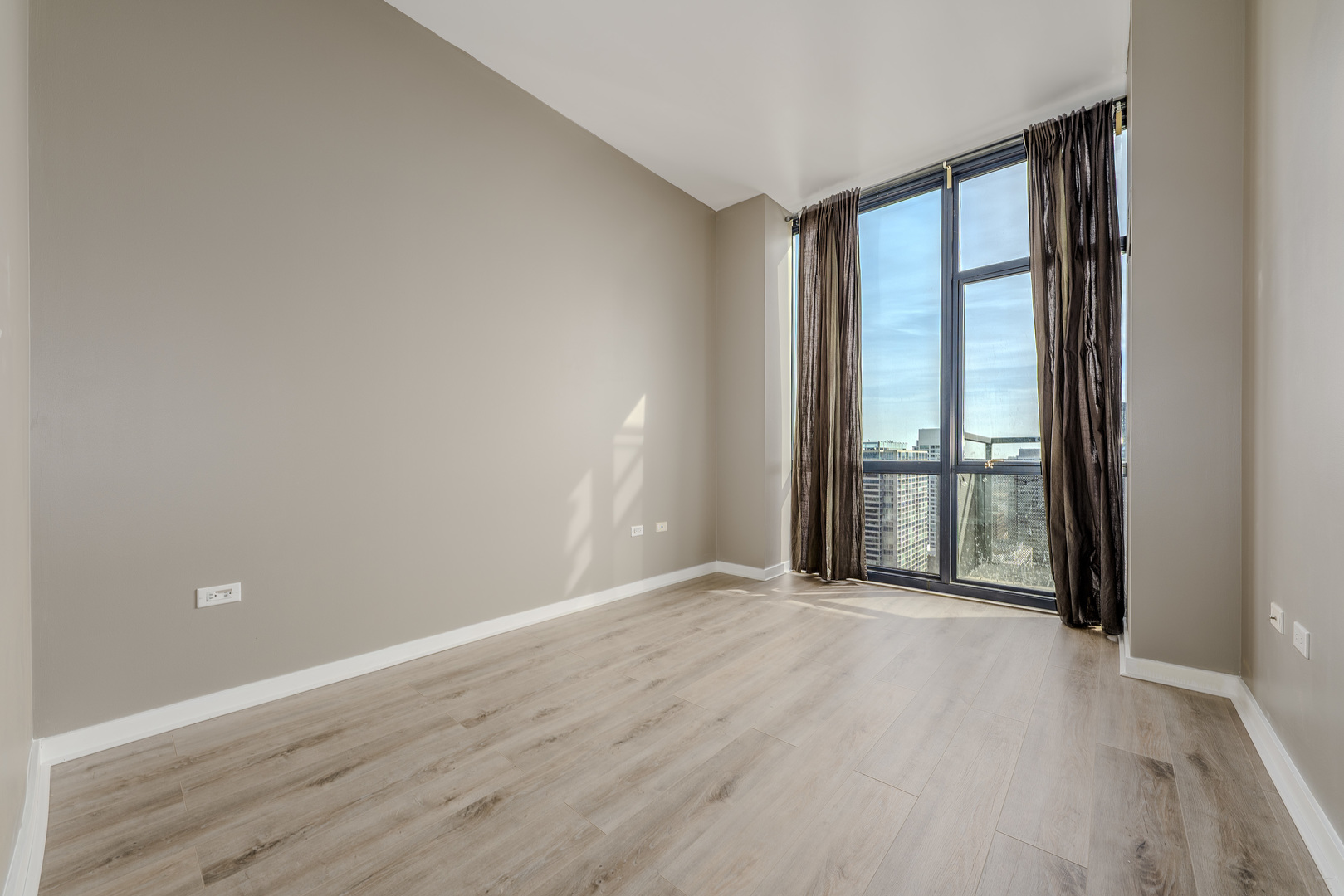 235 West Van Buren Street, Unit 3105 Chicago, IL 60607 - Photo 11 of 29 wooden floor and windows in an empty room