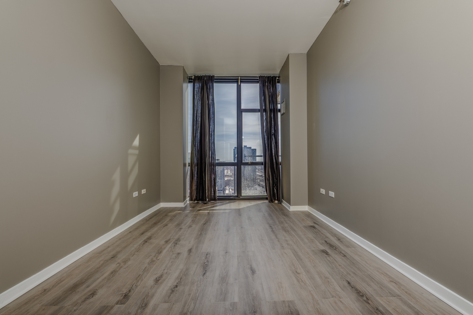 235 West Van Buren Street, Unit 3105 Chicago, IL 60607 - Photo 12 of 29 wooden floor and window in an empty room