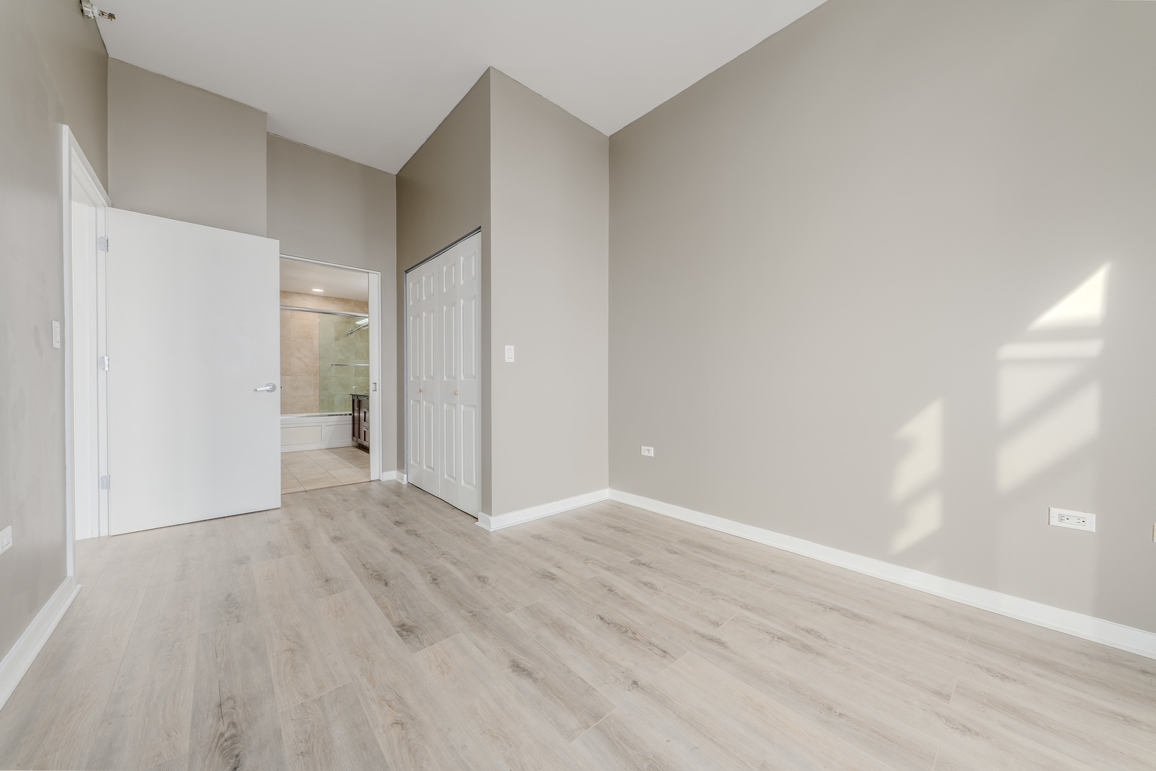 235 West Van Buren Street, Unit 3105 Chicago, IL 60607 - Photo 13 of 29 a view of an empty room with wooden floor