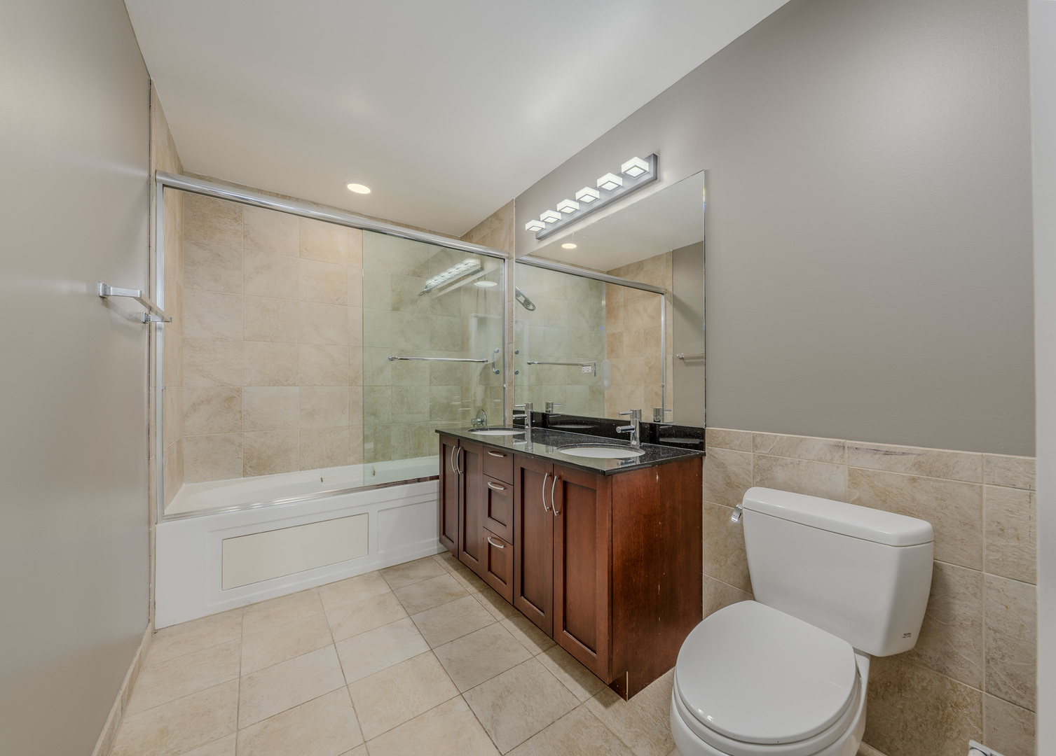 235 West Van Buren Street, Unit 3105 Chicago, IL 60607 - Photo 14 of 29 a bathroom with a granite countertop toilet sink and shower