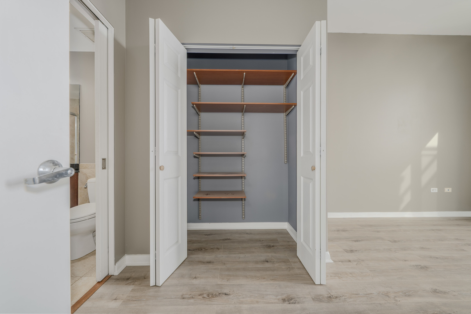 235 West Van Buren Street, Unit 3105 Chicago, IL 60607 - Photo 15 of 29 a view of a hallway with wooden floor and closet