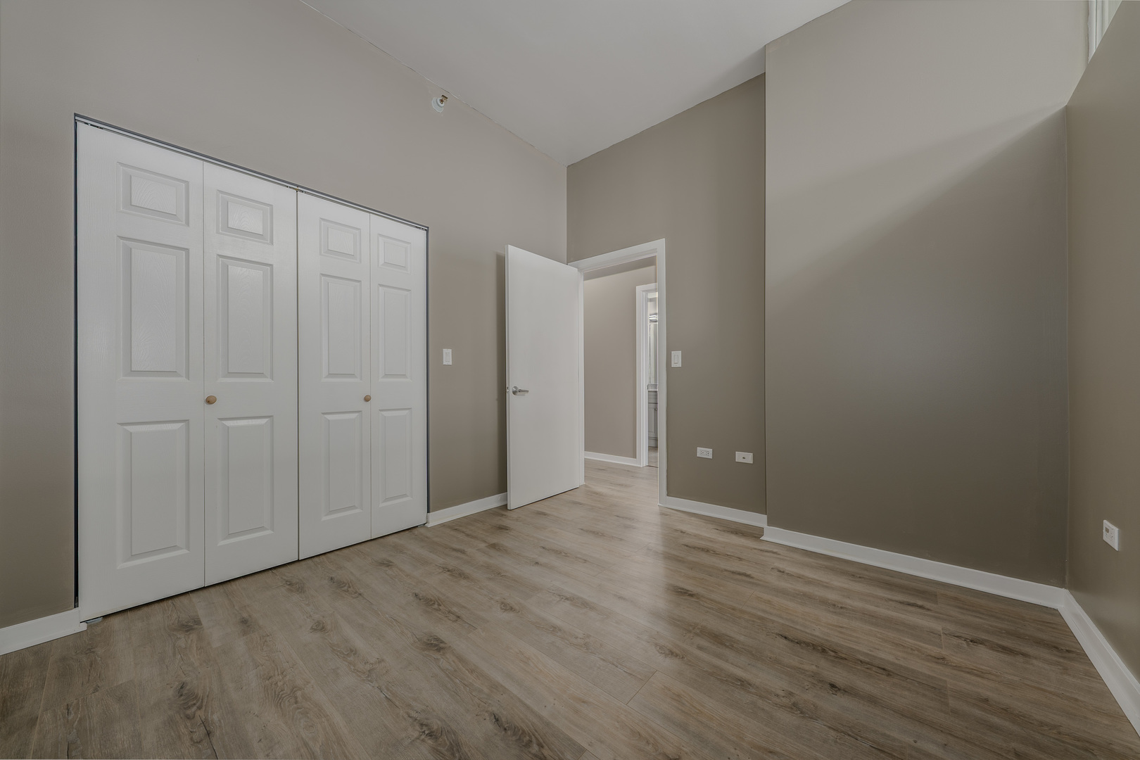 235 West Van Buren Street, Unit 3105 Chicago, IL 60607 - Photo 17 of 29 a view of an empty room with wooden floor