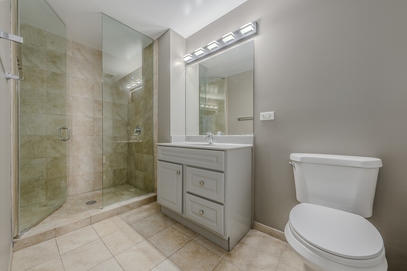 235 West Van Buren Street, Unit 3105 Chicago, IL 60607 - Photo 18 of 29 a bathroom with a toilet a sink and shower