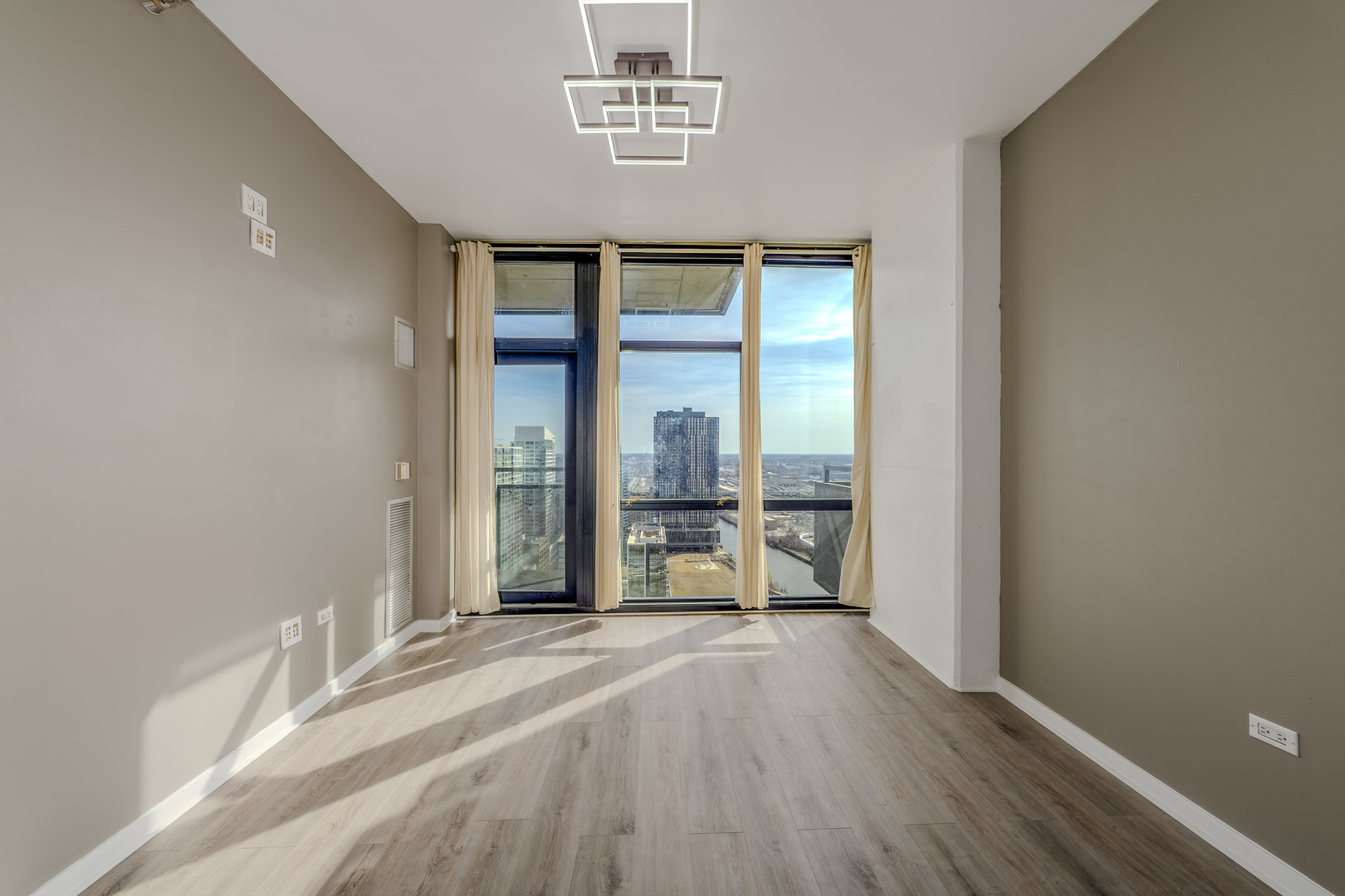 235 West Van Buren Street, Unit 3105 Chicago, IL 60607 - Photo 4 of 29 a view of an empty room with a window